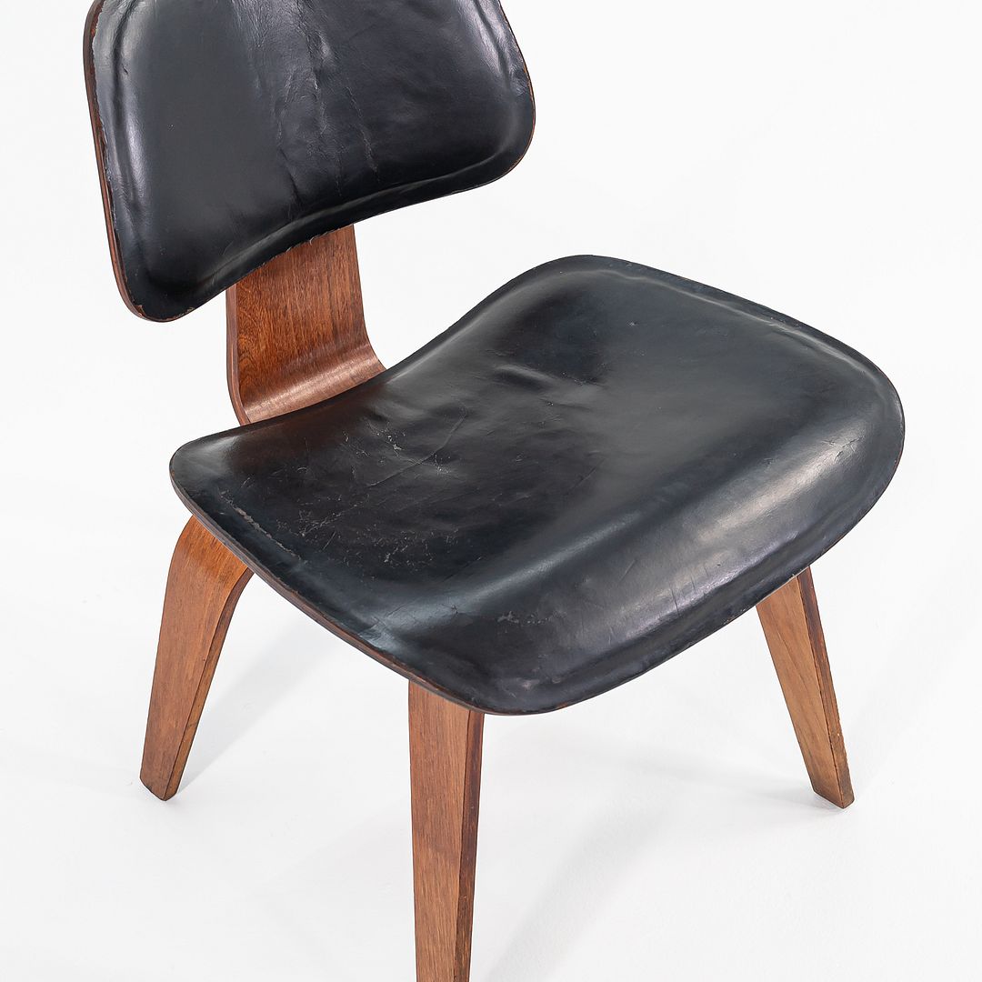 1952 DCW Dining Chair by Charles and Ray Eames for Herman Miller in Walnut with Black Leather Upholstery